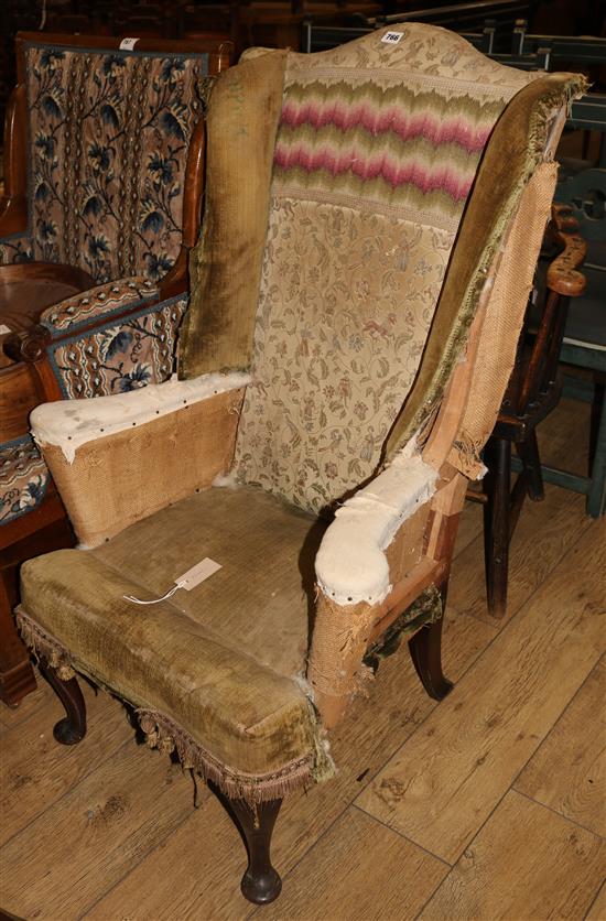 A 1930s mahogany wing armchair
